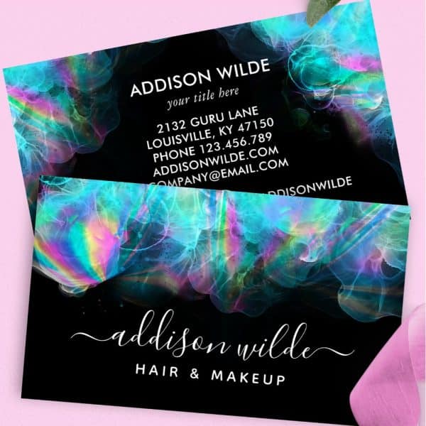 Business Card For Addison Wilde Hair &Amp; Makeup, Featuring A Dark Background With Iridescent Teal And Purple Abstract Design.