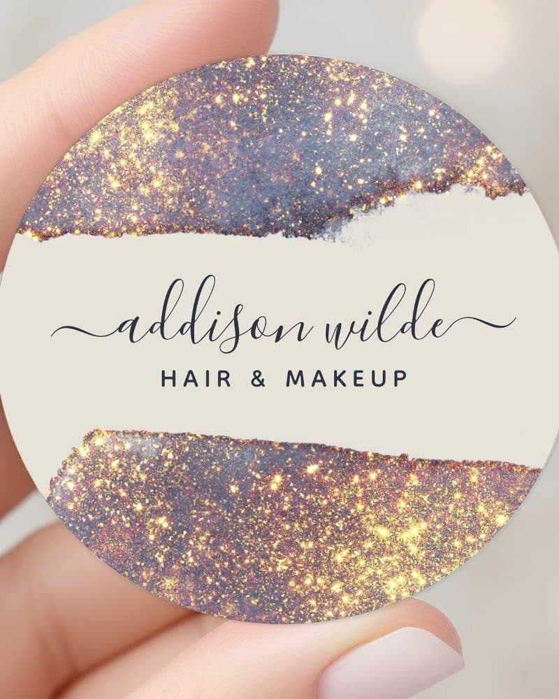 Round hair and makeup business card with gold glitter design and Addison Wilde's name.