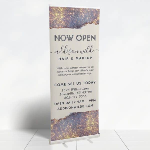 A Retractable Banner Announcing The Grand Opening Of Addison Wilde Hair &Amp; Makeup.