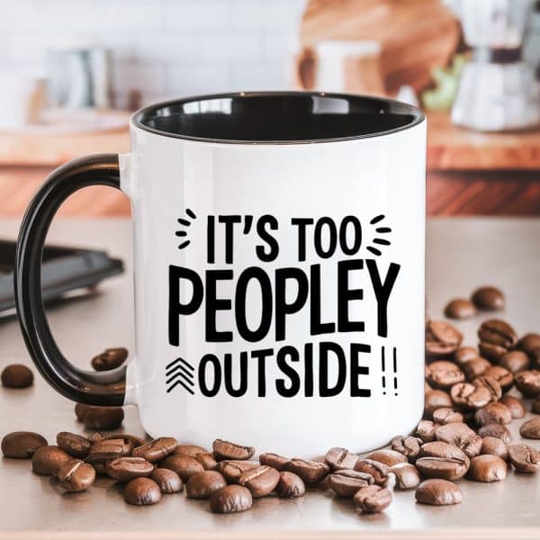 White Coffee Mug With Black Interior And Handle, Displaying The Text: Its Too People Outside. Coffee Beans Are Scattered Around The Mug.