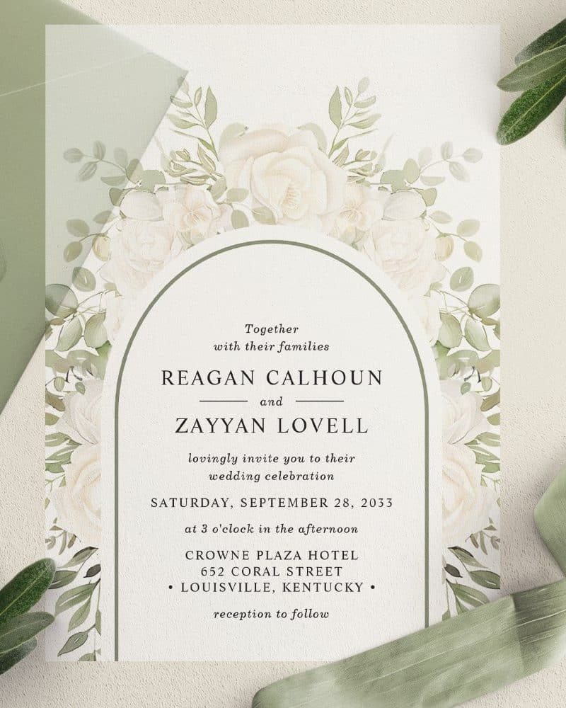 Wedding invitation with watercolor floral arch and couple's names: Reagan Calhoun and Zayyan Lovell.
