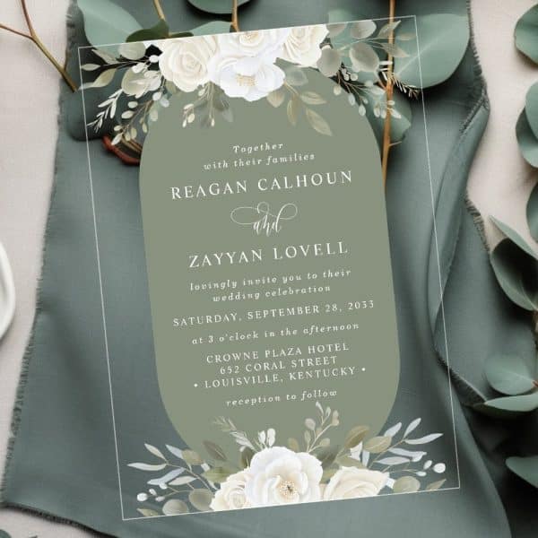 Wedding Invitation With White Roses And Greenery, Announcing The Marriage Of Reagan Calhoun And Zayyan Lovell.