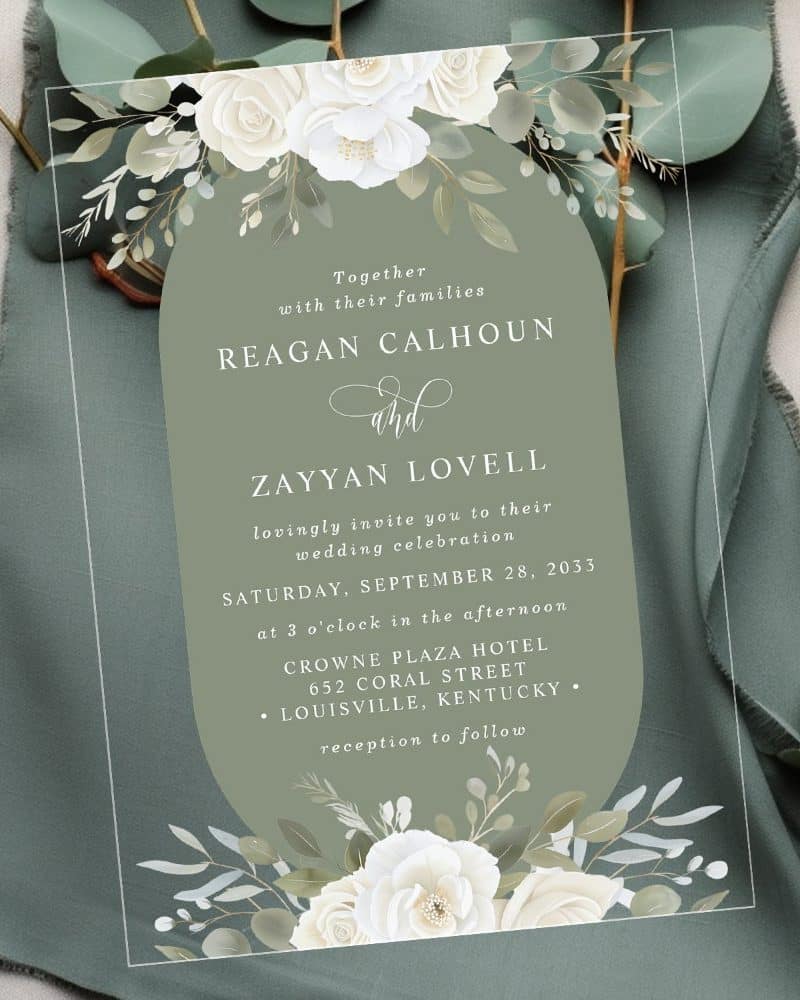 Wedding invitation with white roses and greenery, announcing the marriage of Reagan Calhoun and Zayyan Lovell.