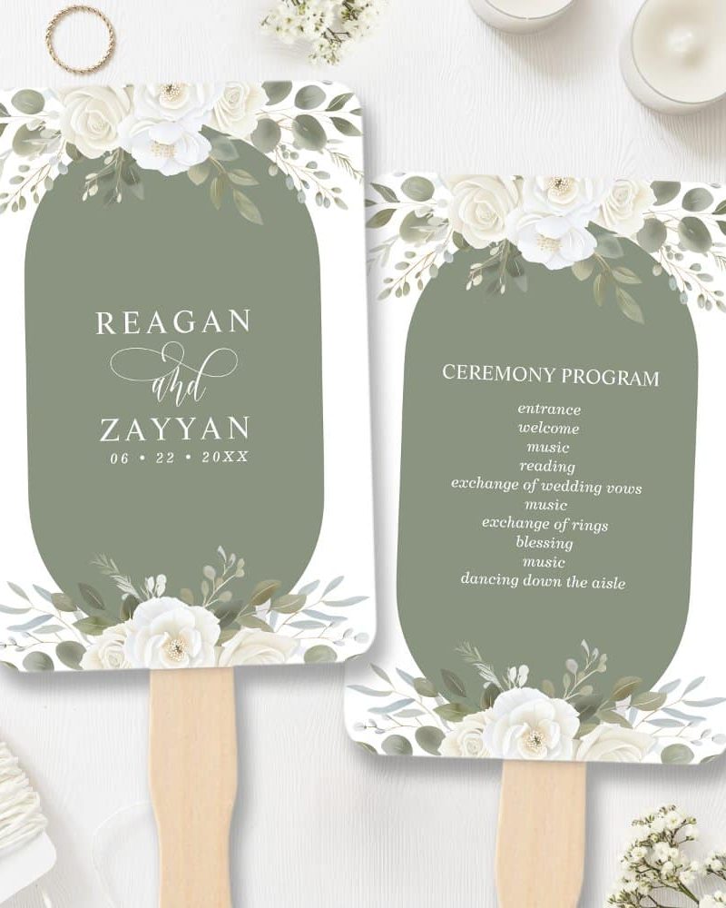Two wedding ceremony hand fans, one with the couple's names and wedding date, the other with the ceremony program. Both feature white flowers and greenery on an olive green background.