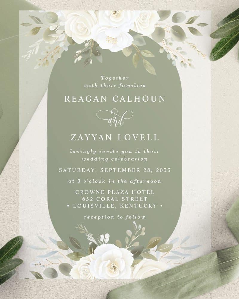 Wedding invitation with white flowers and green accents, announcing the marriage of Reagan Calhoun and Zayyan Lovell.