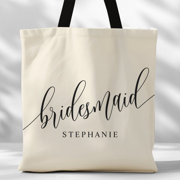 Beige Tote Bag With Black Script Lettering That Says Bridesmaid Stephanie.