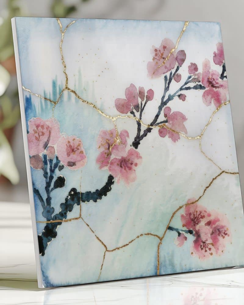 Square artwork depicting pink cherry blossoms on a light blue background with gold crackle detailing.