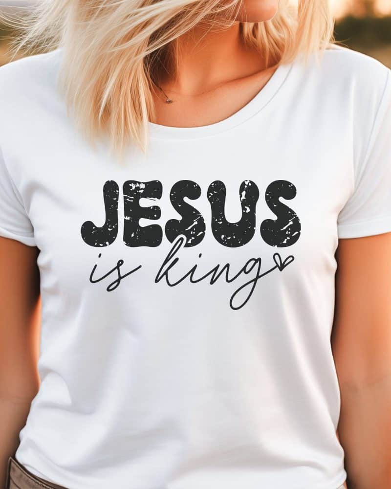 Woman wearing a white t-shirt with the text Jesus is King.