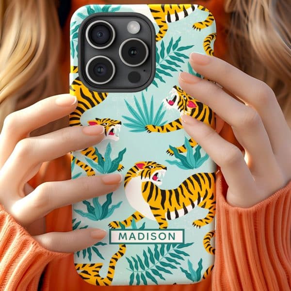 Person Holding A Phone Case With A Teal Background, Orange Tigers, And Green Leaves. The Name Madison Is On The Case.