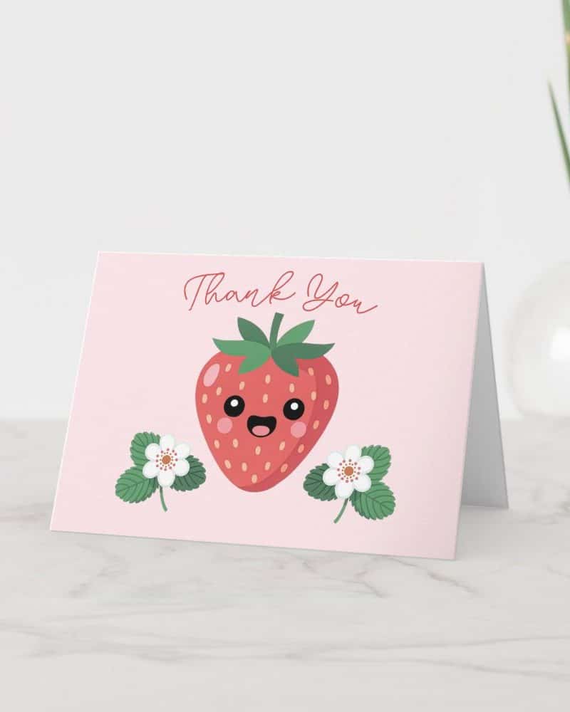 Thank you card featuring a happy cartoon strawberry and flowers.