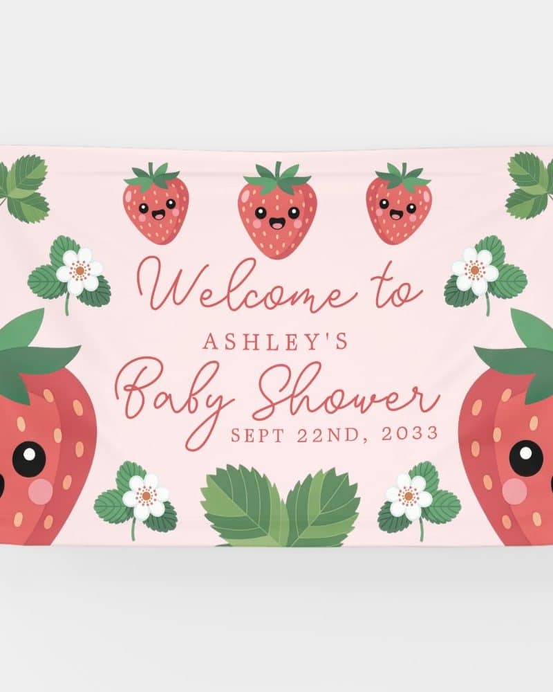 Pink baby shower banner featuring cartoon strawberries and the text Welcome to Ashley's Baby Shower, Sept 22nd, 2033.
