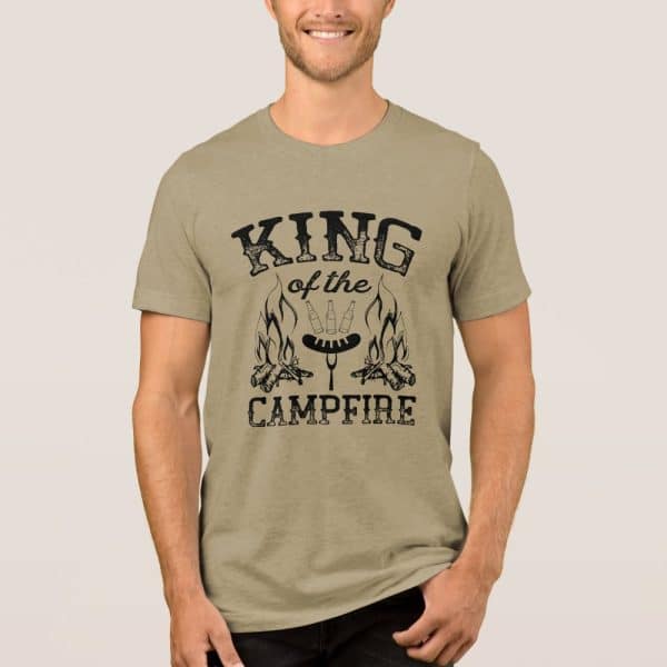 Tan T-Shirt With A Design Reading King Of The Campfire, Showing A Campfire With Hotdogs And Beer Bottles.