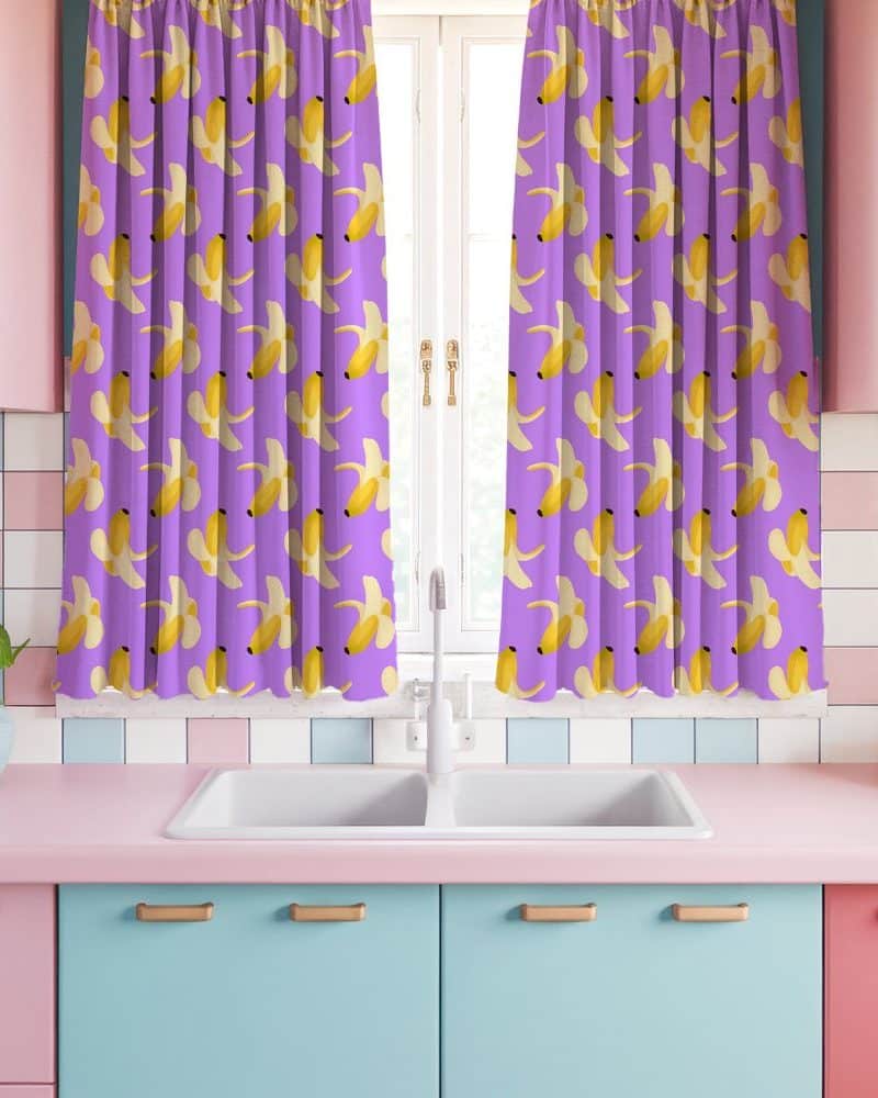 Purple kitchen window curtains with a repeating pattern of peeled bananas.