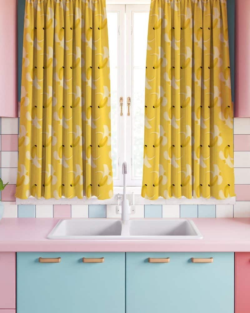 Yellow banana patterned kitchen curtains hanging in a retro kitchen.