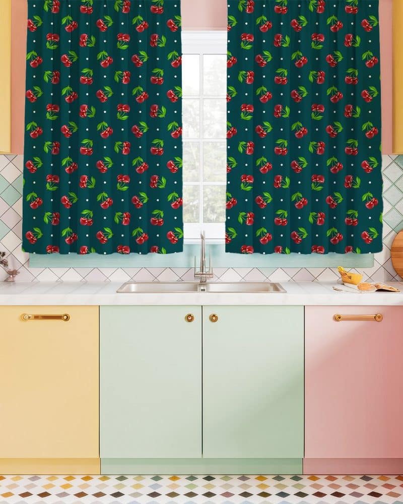 Teal kitchen window curtains with a red cherry pattern.