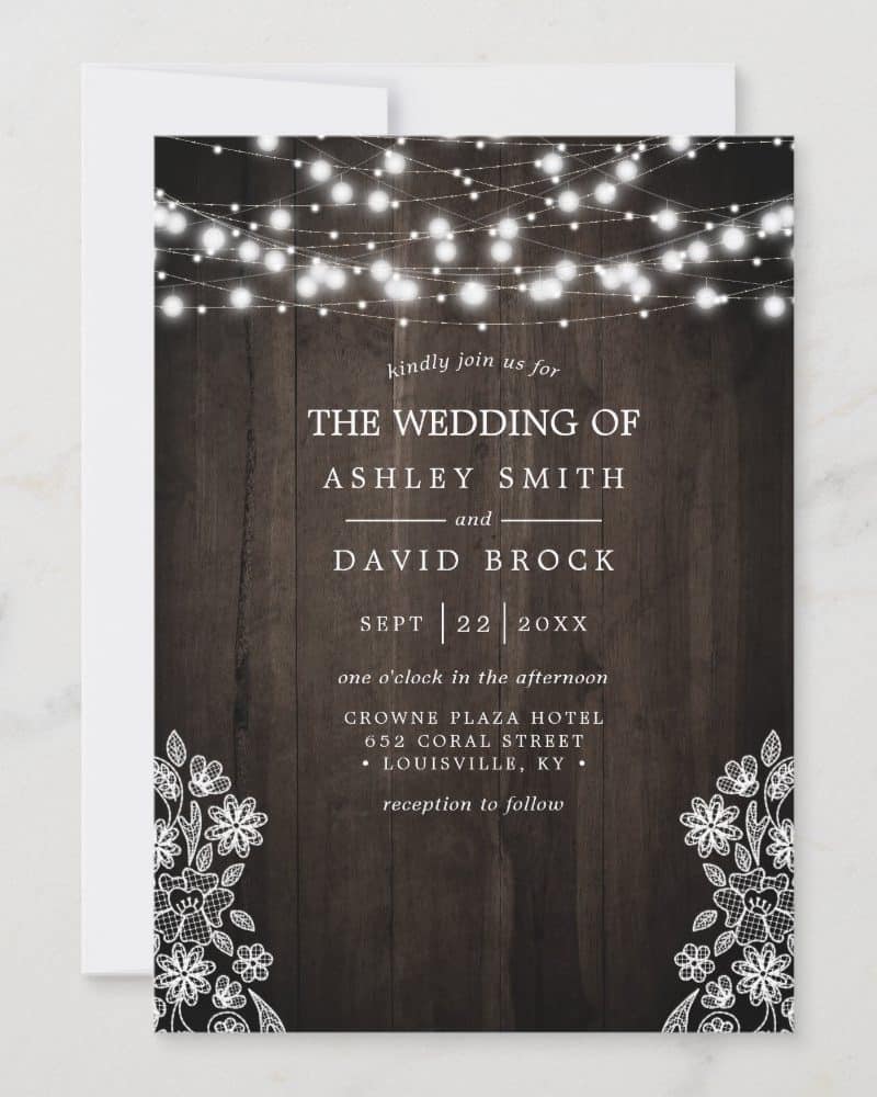 Wedding invitation for Ashley Smith and David Brock, featuring string lights and lace designs on a wood background.