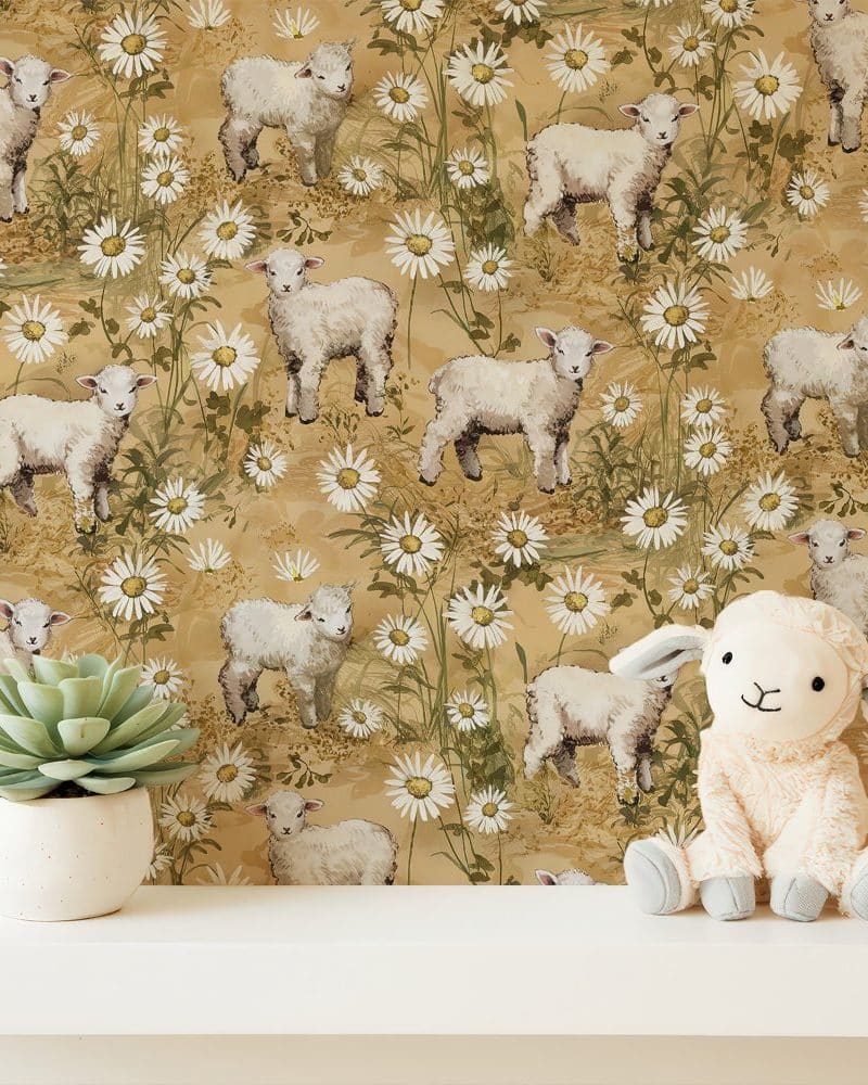 A tan lambs and daisies wallpaper with a plush lamb toy in the foreground.