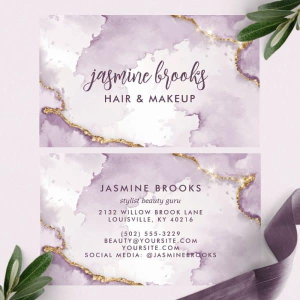 Two Business Cards For Jasmine Brooks, Hair And Makeup Stylist, Featuring A Watercolor Design In Shades Of Purple And Gold Accents.