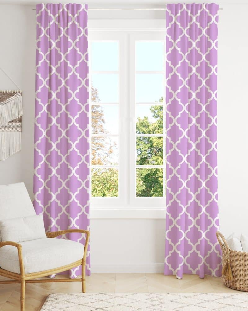 Lavender curtains with a quatrefoil pattern hang on a window.