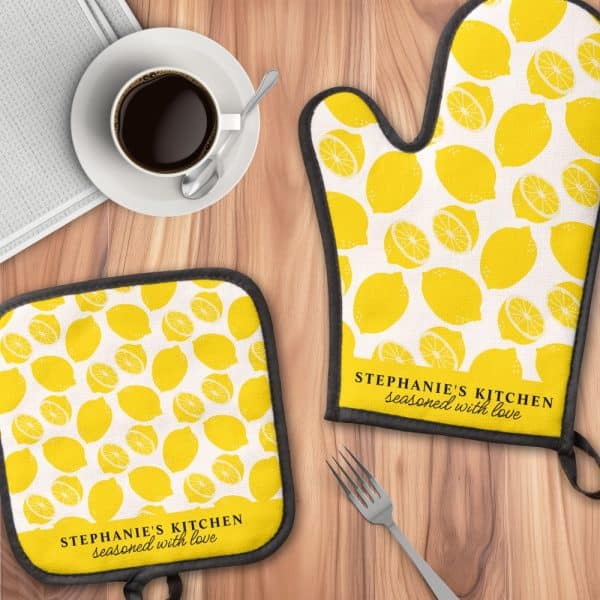 A Lemon-Printed Oven Mitt And Pot Holder Set, Personalized With The Text &Quot;Stephanie'S Kitchen, Seasoned With Love&Quot;.