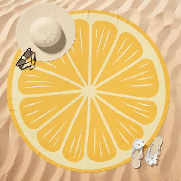 Round Lemon Slice Beach Towel On Sand.