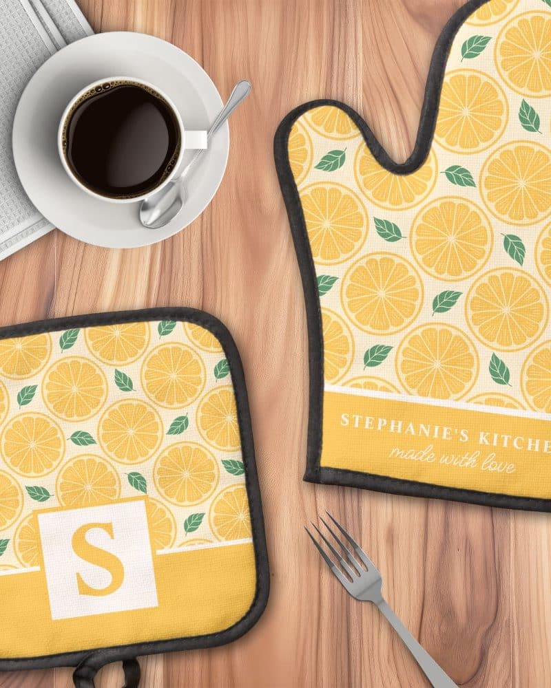 Lemon-printed oven mitt and pot holder set, personalized with a name and initial.