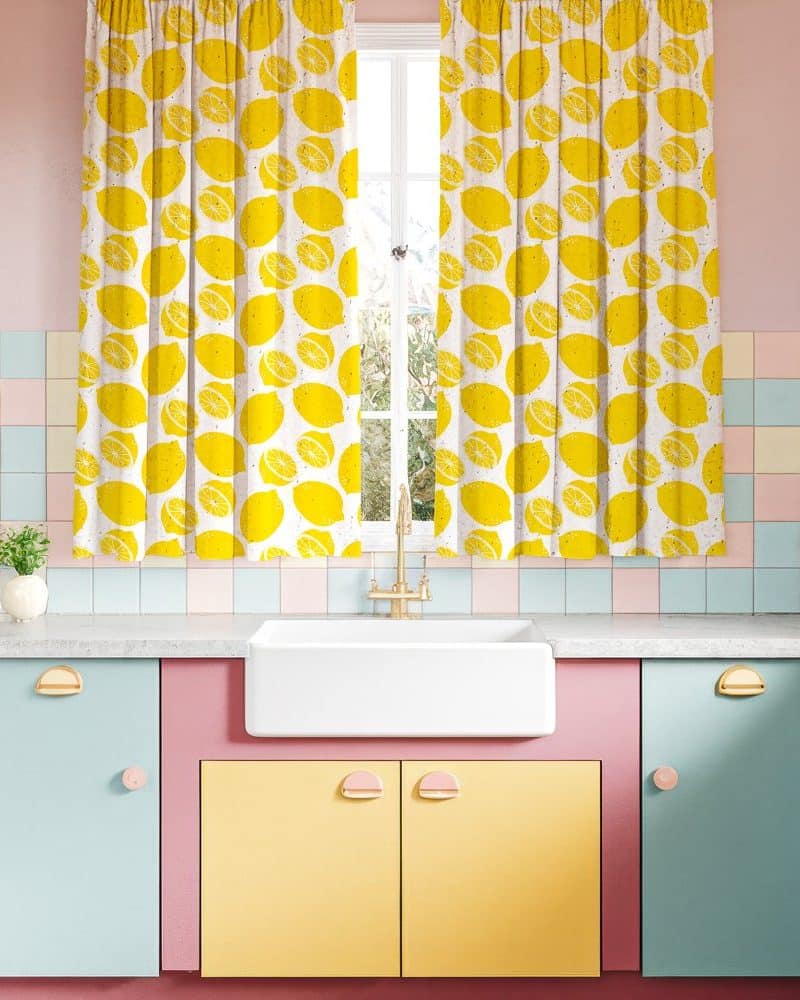 A pastel kitchen with lemon-patterned curtains.
