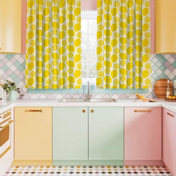 Lemon-Printed Kitchen Curtains Hanging Above A Pastel-Colored Kitchen Sink And Cabinets.