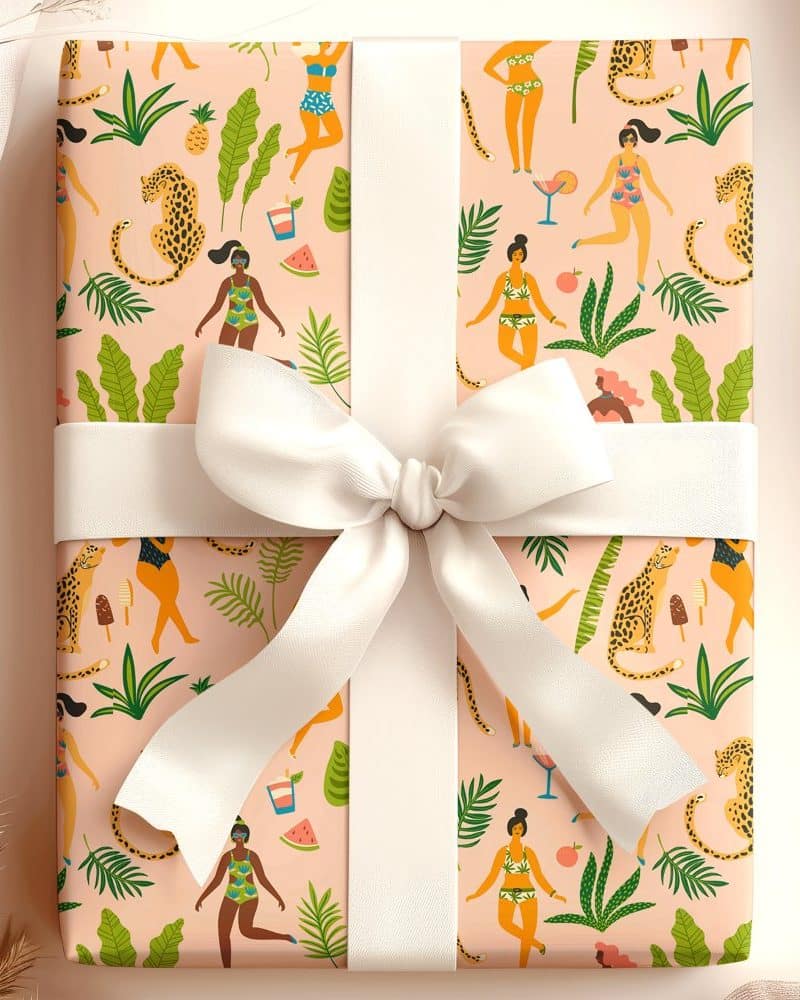 Gift wrapped in pink paper featuring a repeating pattern of women in swimsuits, leopards, tropical plants, and summer drinks. A white ribbon is tied in a bow on top.