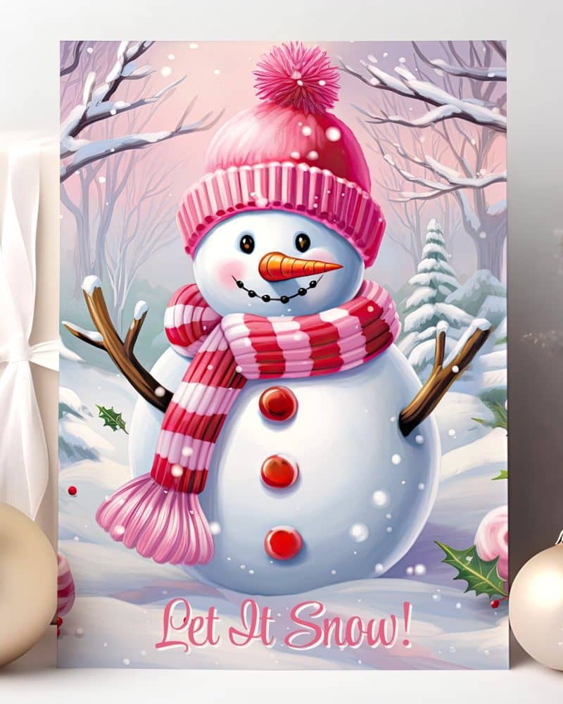 A cheerful snowman wearing a pink hat and scarf stands in a snowy winter scene. The words Let It Snow are at the bottom.