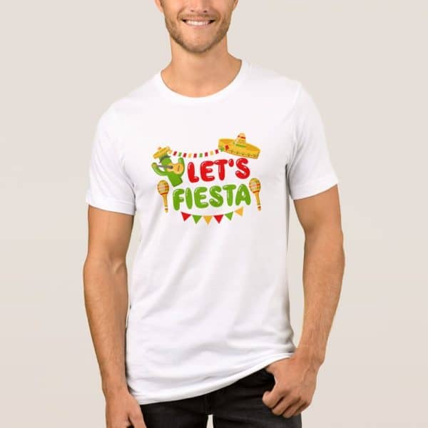 A Man Is Modeling A White T-Shirt With A Festive Design. The Design Includes The Text Lets Fiesta, Along With A Cactus Playing A Guitar, Maracas, And A Sombrero.
