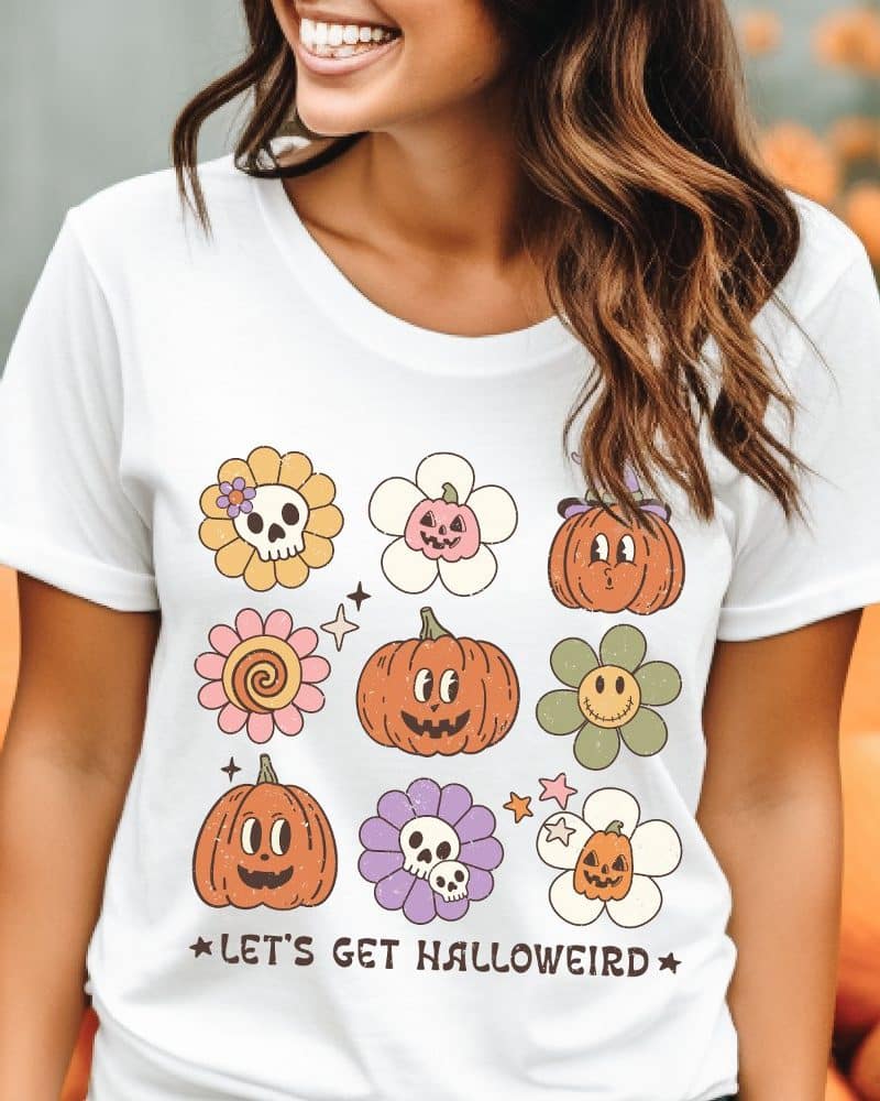 White t-shirt with a retro Halloween design featuring pumpkins and flowers.