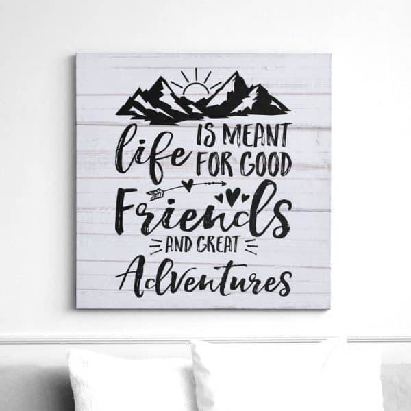 Canvas Print With A Woodgrain Background Featuring A Quote: Life Is Meant For Good Friends And Great Adventures. A Mountain Sun Graphic Is Above The Text.