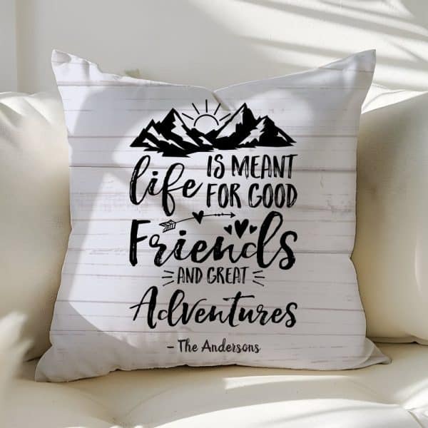 White Throw Pillow With Black Text And Mountain Graphic; The Text Reads Life Is Meant For Good Friends And Great Adventures.