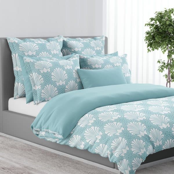 Light Teal Duvet Cover And Pillow Set With A White Seashell Pattern.