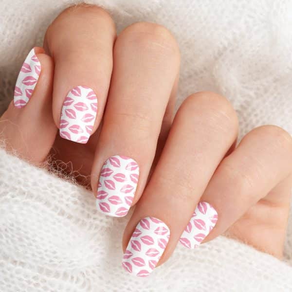Hand With Fingernails Decorated With Pink Lips Pattern.