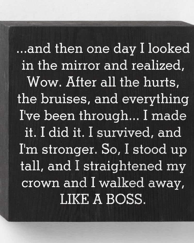 Black square sign with inspirational text about overcoming adversity and emerging stronger.
