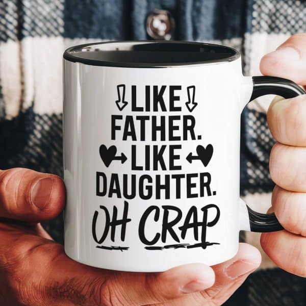 A Hand Holds A White Coffee Mug With Black Text That Says Like Father, Like Daughter, Oh Crap.