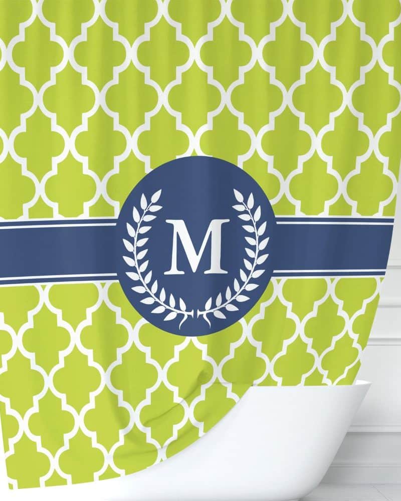 Lime green shower curtain with a navy blue and white monogram featuring the letter M.