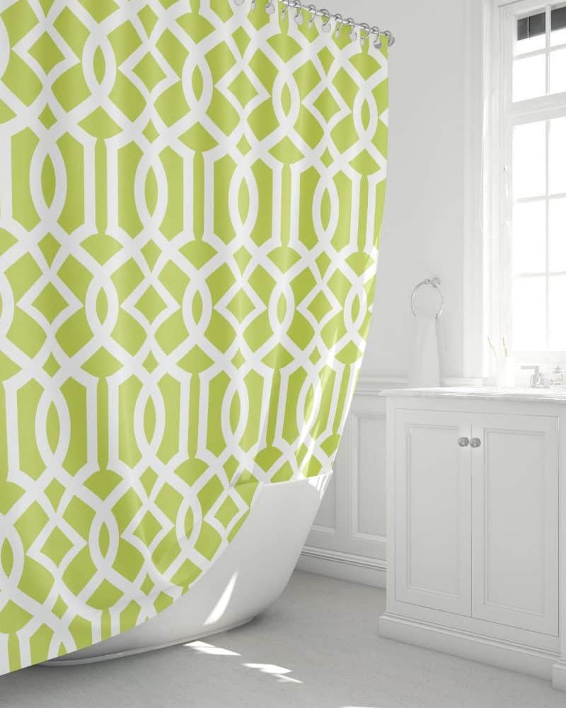 Lime green and white geometric patterned shower curtain in a bright bathroom.