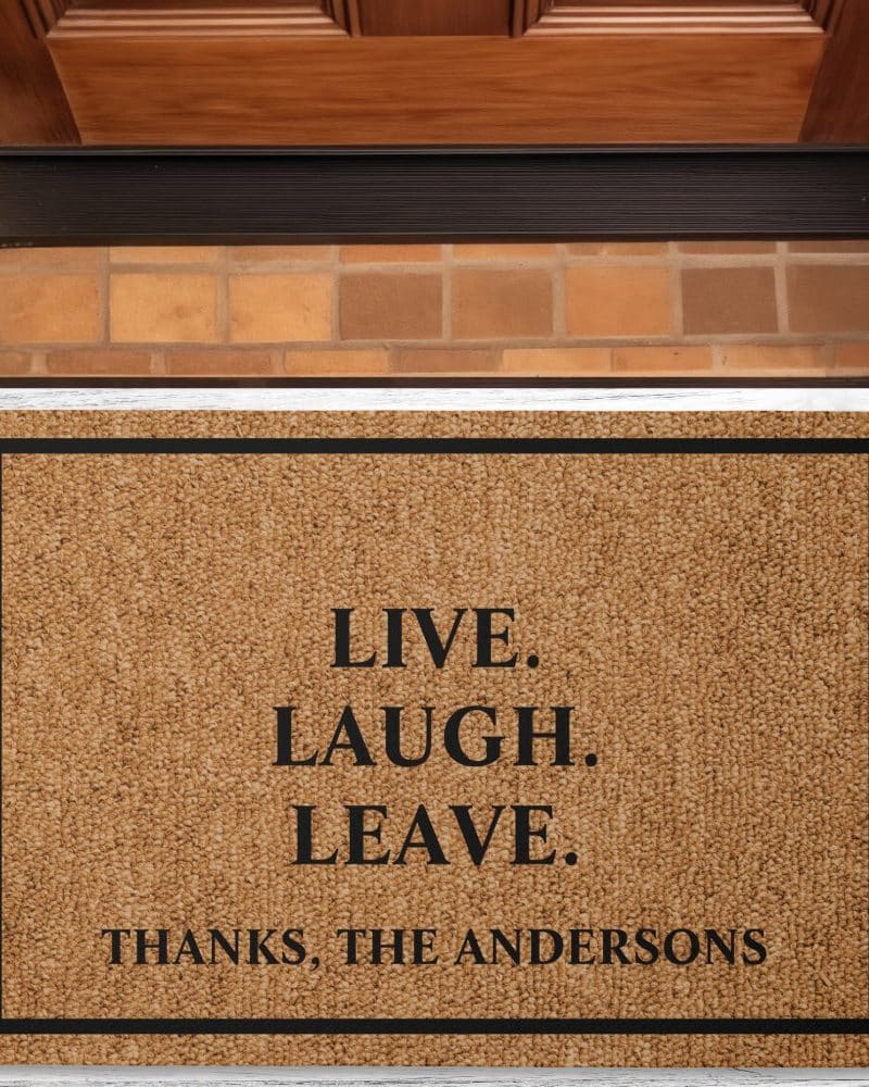 Brown coir doormat with black border and text: Live. Laugh. Leave. Thanks, The Andersons.