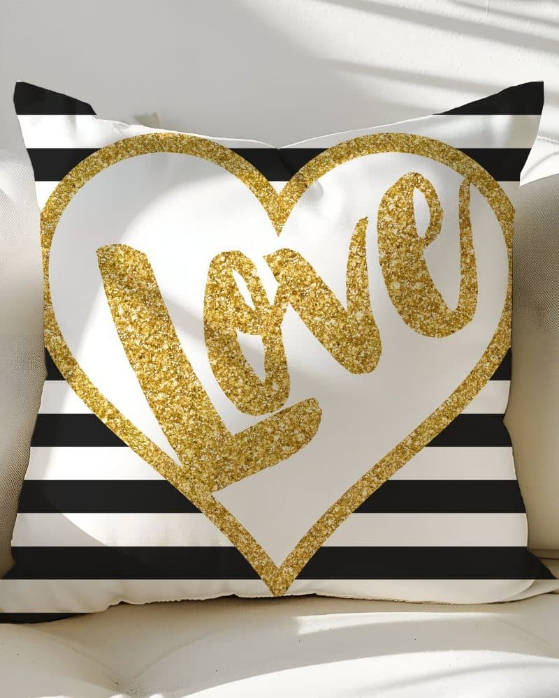 Gold glitter Love heart on black and white striped pillow.