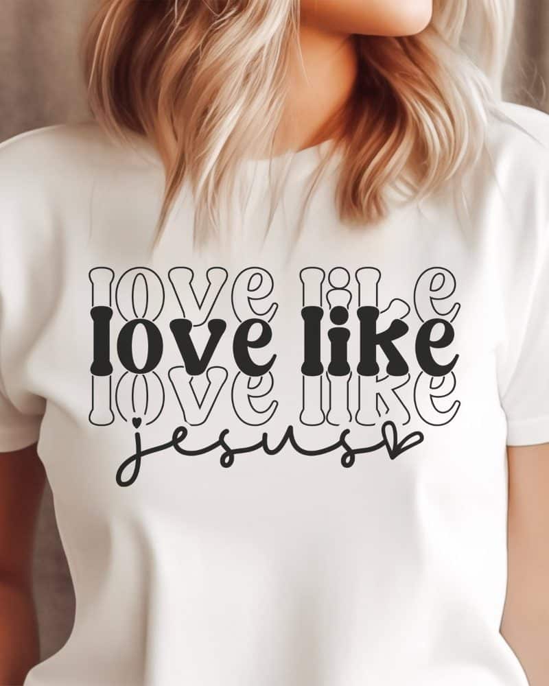 White t-shirt with the phrase Love Like Jesus in a stylized retro font.
