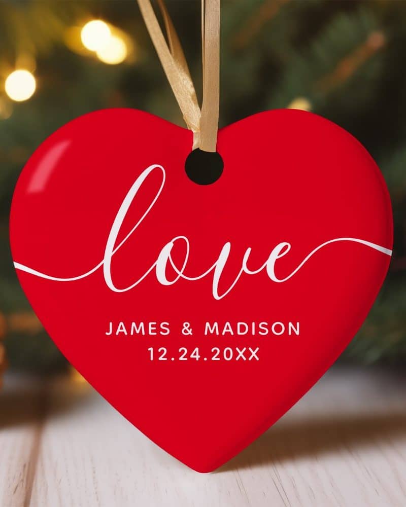 Red heart-shaped ornament with the word Love and a wedding date.