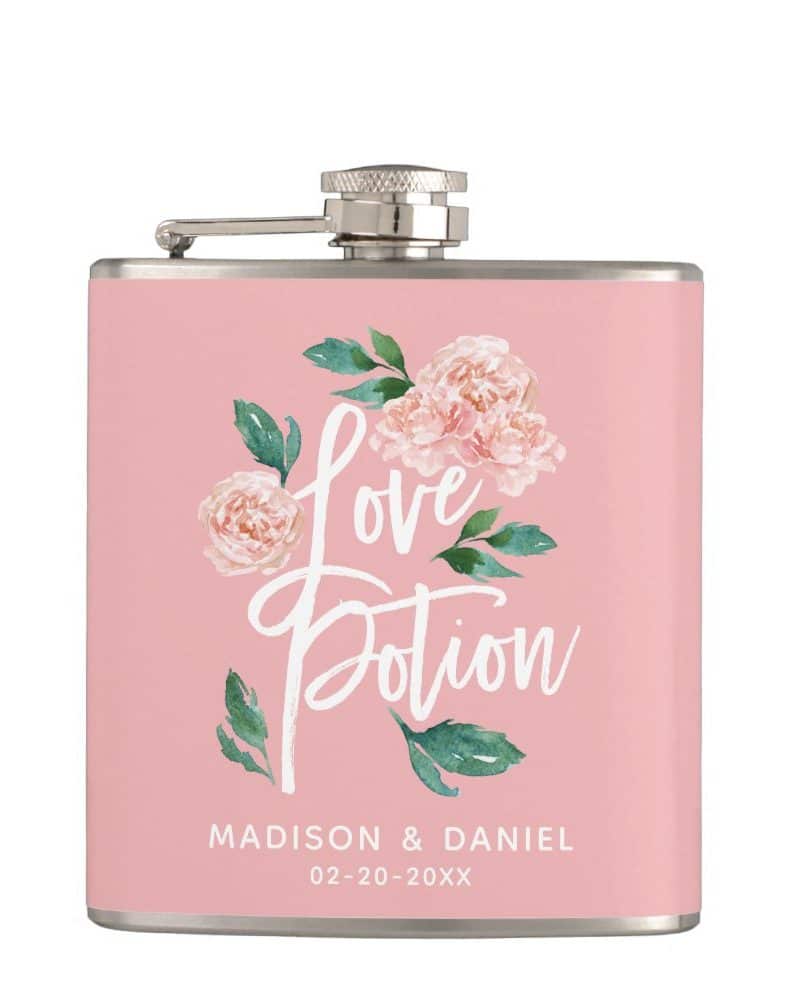 Pink flask with a floral design and the words Love Potion. A wedding date is also visible at the bottom.