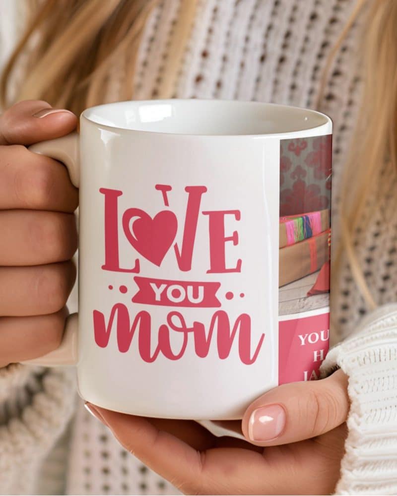 A woman's hands hold a white coffee mug with pink lettering that says Love You Mom.