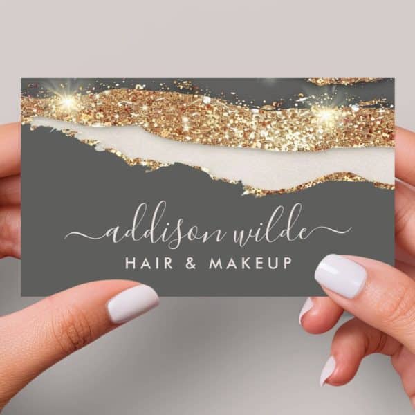 A Gray Business Card With Gold Glitter Detailing And The Name Addison Wilde, Hair &Amp; Makeup.
