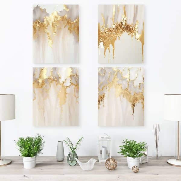 Four Square Abstract Art Prints, Featuring Beige And Gold Paint Splatter, Displayed On A Wall.