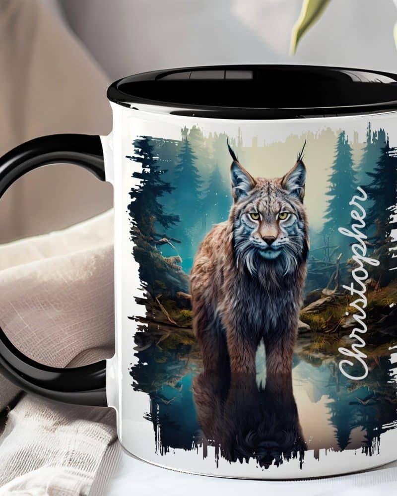 Black-handled mug featuring a lynx reflected in a dark, forest pool. The name Christopher is visible on the mug.