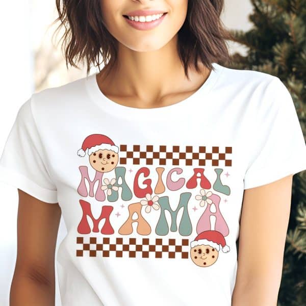 Woman Wearing A White T-Shirt With A Retro Design That Says Magical Mama And Features Christmas Cookie Illustrations.